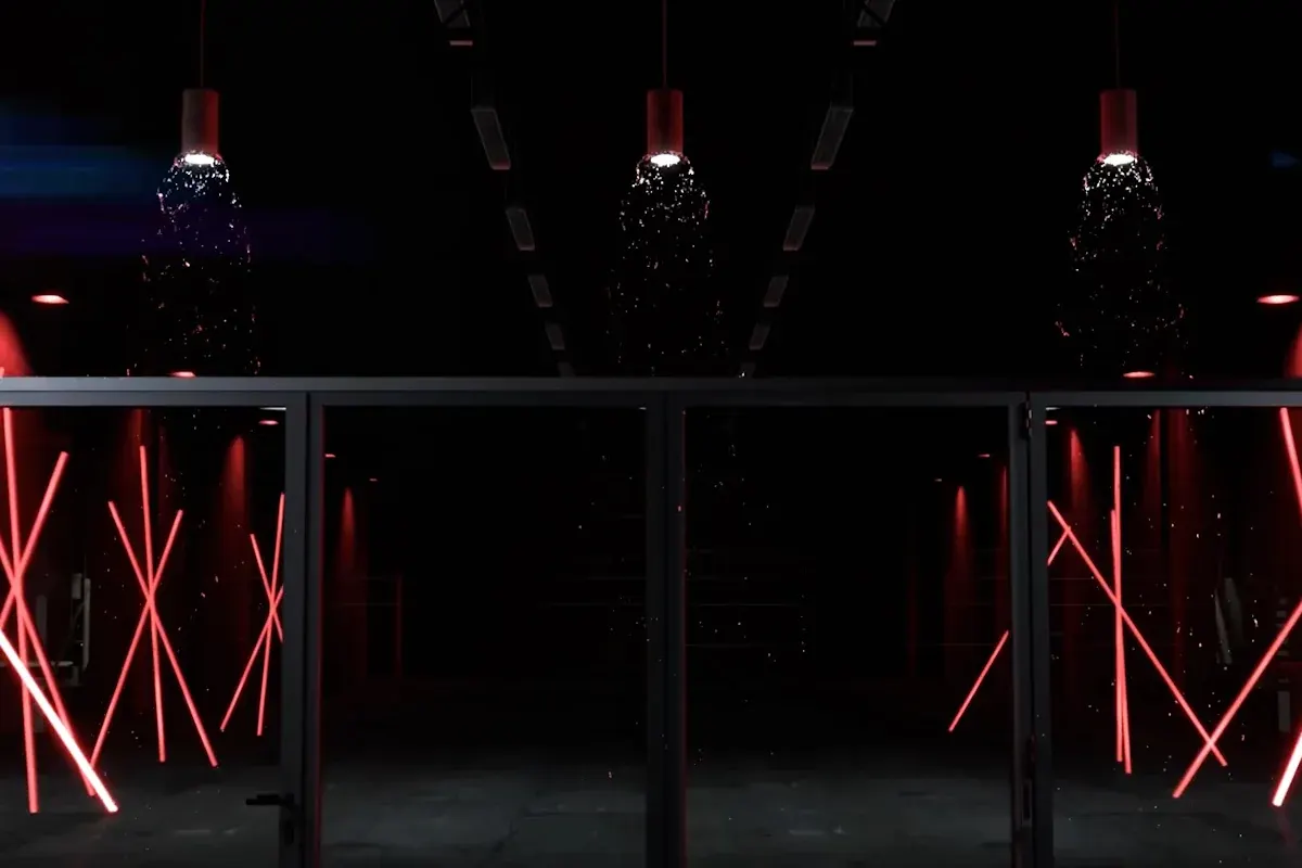 The F82 launch scene, glass and black aluminium doors in a dark warehouse with red neon tubes behind them.